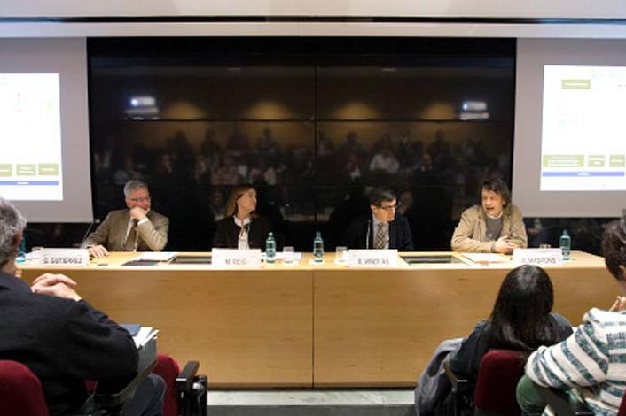 Mesa con cuatro ponentes en una conferencia